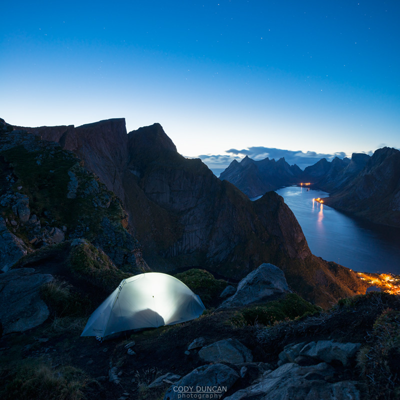 Tent camping on narrow ridge of summit of Reinebringen mountain peak, Reine, Moskenesoy, lofoten Islands, Norway