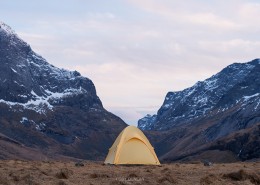Tent with scenic mountain backdrop while wild camping at Horseid beach, Moskenesøy, Lofoten Islands, Norway