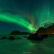 Northern Lights - Aurora Borealis shine in Sky over Uttakleiv beach, Vestvågøy, Lofoten Islands, Norway