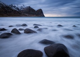 Waves flow among boulders at scenic Unstad beach, Vestvågøy, Lofoten Islands, Norway