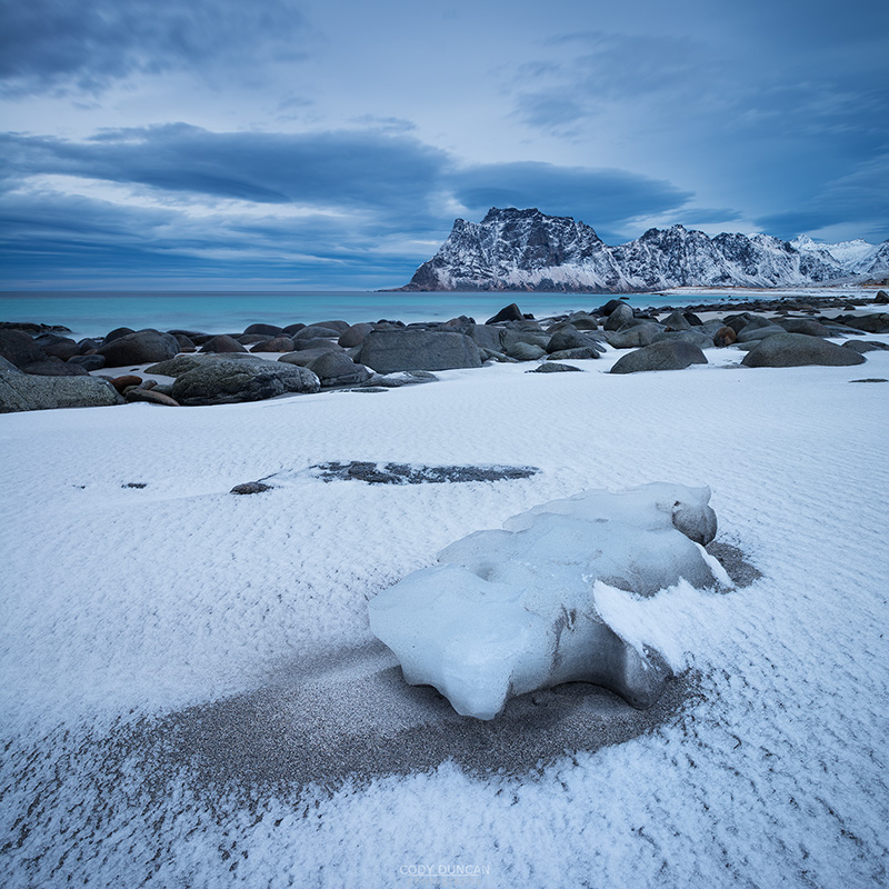 Dusting of snow covers sand at Uttakleiv beach, Vestvågøy, Lofoten Islands, Norway