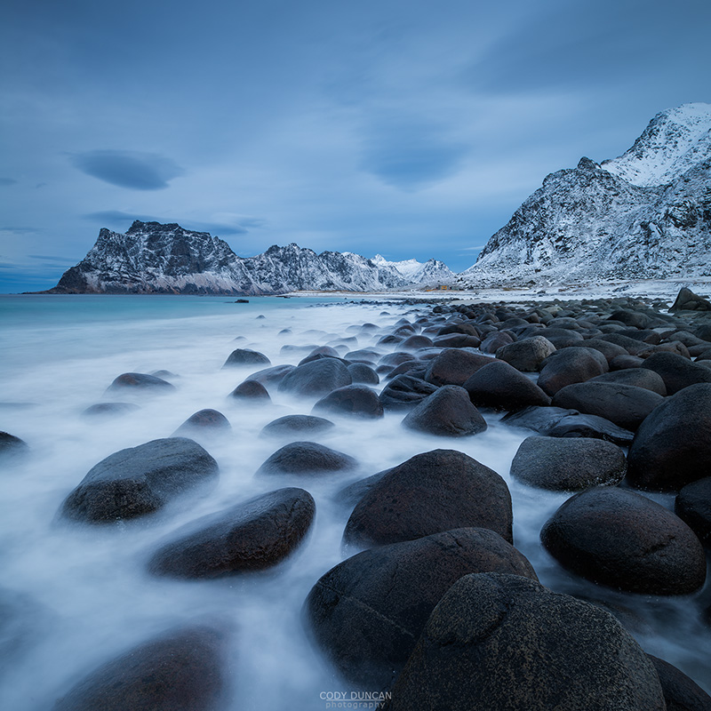 Waves wash over coastal rocks at Uttakleiv beach, Vestvågøy, Lofoten Islands, Norway