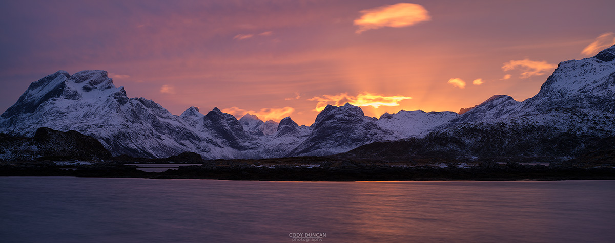 Colorful sunset over mountains of Moskenesøy, near Fredvang, Flakstadøy, Lofoten Islands, Norway