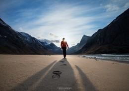 Female hiker leaves footprints in sand on scenic Horseid beach, Moskenesøy, Lofoten Islands, Norway