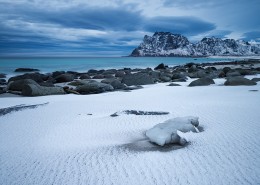 Dusting of snow covers sand at Uttakleiv beach, Vestvågøy, Lofoten Islands, Norway