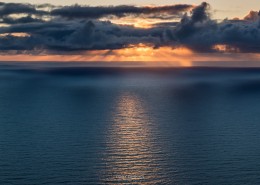 Late summer sun low on horizon over Norwegian sea, Lofoten Islands, Norway
