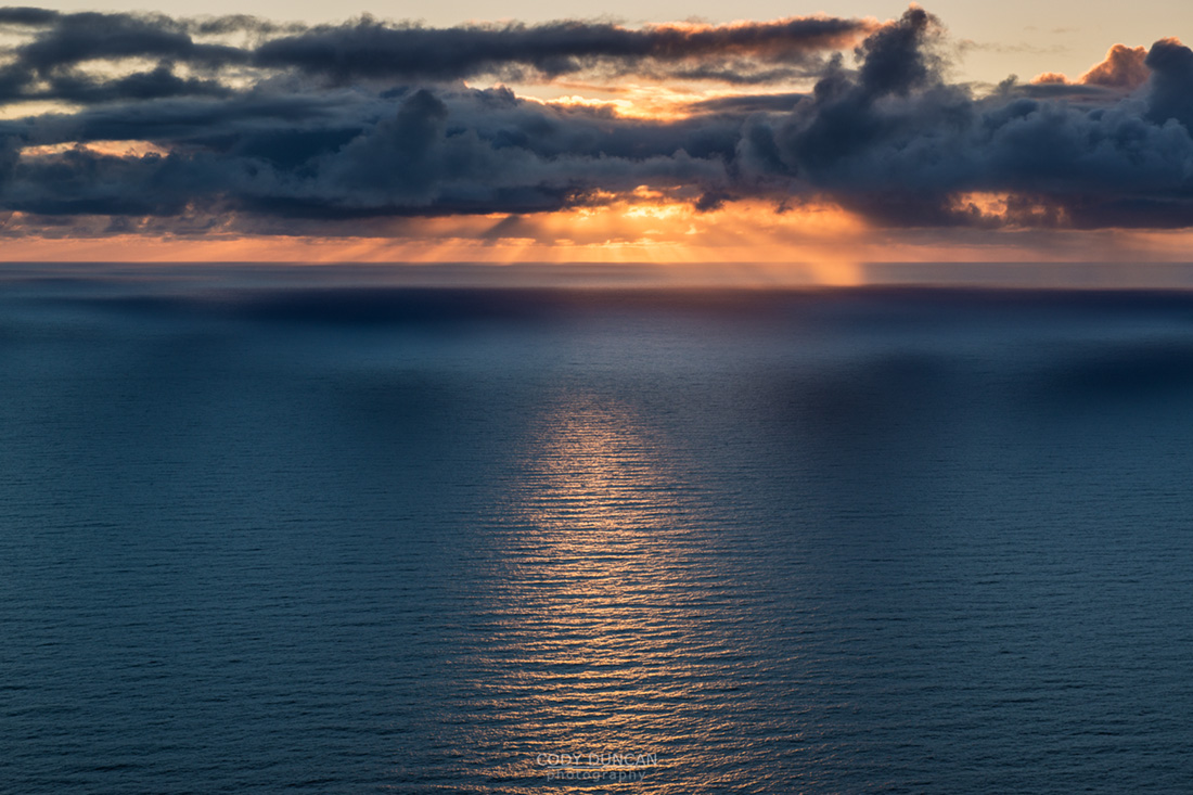 Late summer sun low on horizon over Norwegian sea, Lofoten Islands, Norway