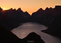 Sunset behind rugged mountain peaks and Kjerkfjord from Reinebringen peak, Reine, Lofoten islands, Norway