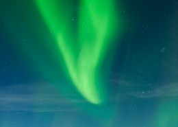 Northern Lights fill sky over sea and mountains, Stamsund, Vestvagoy, Lofoten islands, Norway