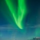 Northern Lights fill sky over sea and mountains, Stamsund, Vestvagoy, Lofoten islands, Norway