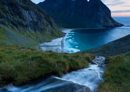 View of river flowing towards Kvalvika beach, Moskenesøy, Lofoten Islands, Norway
