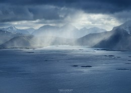 Summer snow flurries approach over sea, Austvågøy, Lofoten Islands, Norway