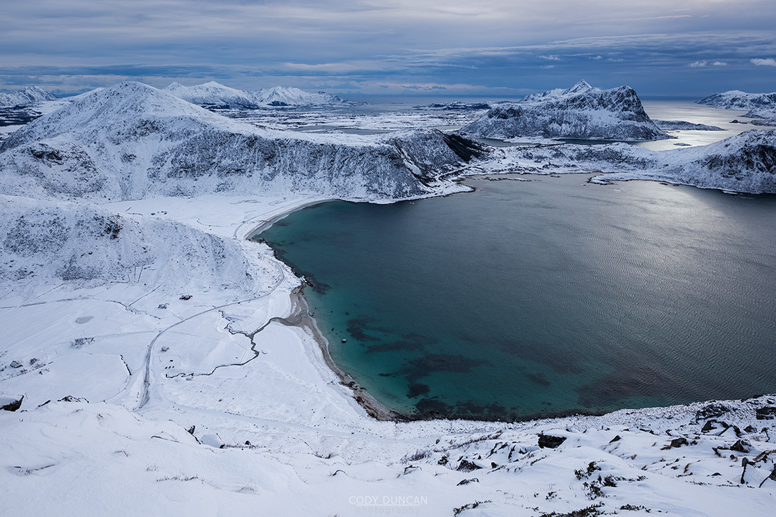 Winter view over snow covered Haukland and Vik beaches from summit of Mannen, Vestvågøy, Lofoten Islands, Norway