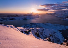 Low winter sun in January over coastal mountain landscape from Offersøykammen, Vestvågøy, Lofoten Islands, Norway