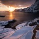 Winter sunser over snow covered coast at Å, Moskenesøy, Lofoten Islands, Norway