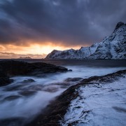 Winter sunser over snow covered coast at Å, Moskenesøy, Lofoten Islands, Norway