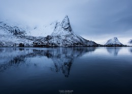 Hammarskaftet mountain peak reflecting in Reine harbor, Moskenesøy, Lofoten Islands, Norway